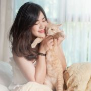 Woman holding her feline friend Woman holding her feline friend